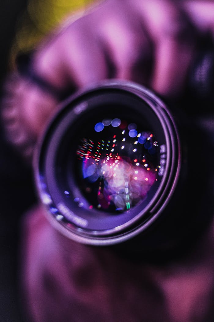 about-01 Vibrant reflections in a camera lens; an artistic photography close-up.